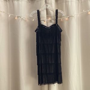 Flapper costume black, fits size women’s 6/8. Stretchy, short hemline.
